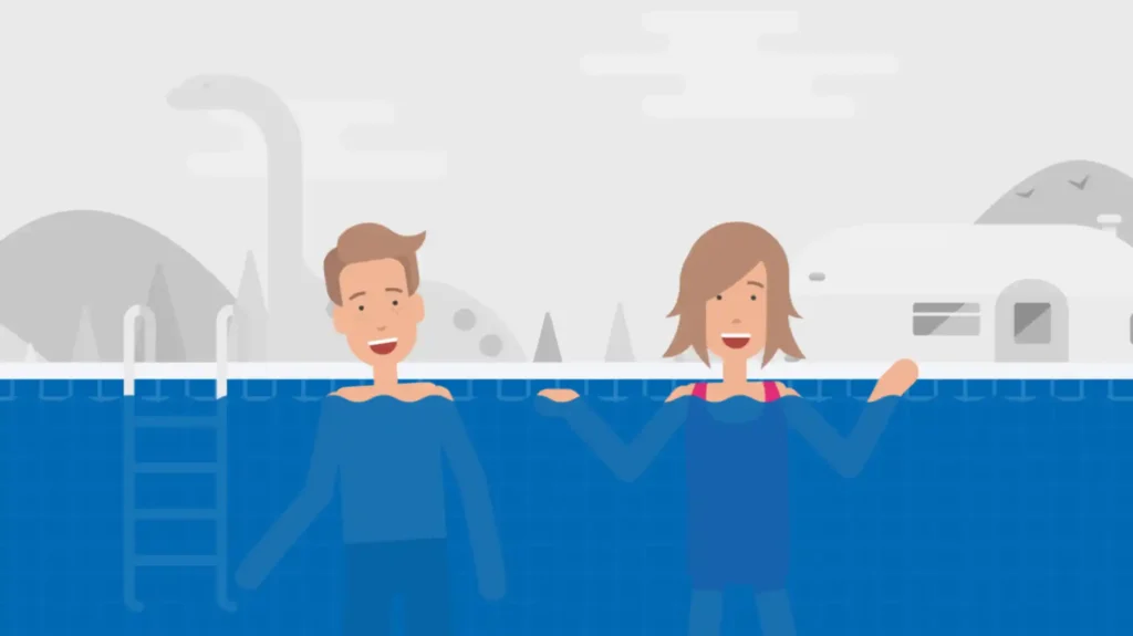 Two customers in a swimming pool with water up to their chests, smiling and waving, with a gray outdoor background.